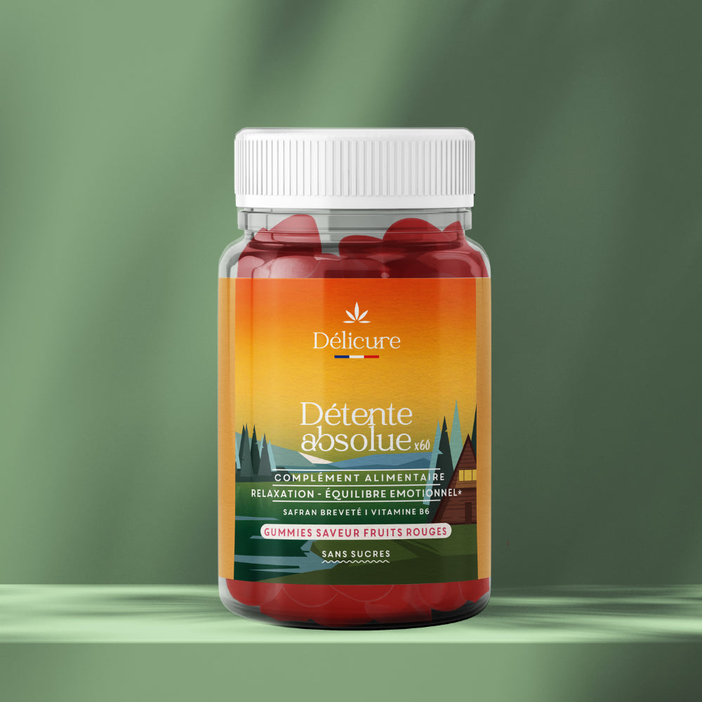 Pot transparent à bouchon blanc rempli de gummies rouges en forme de cœur, étiquette dégradé orange‑vert « Détente absolue x60 » de la marque Délicure, indiquant « complément alimentaire relaxation – équilibre émotionnel », « safran breveté & vitamine B6 », « gummies saveur fruits rouges », « sans sucres ».
